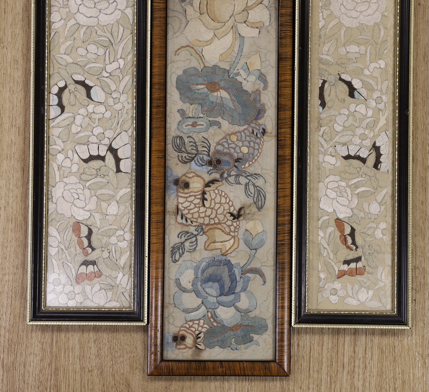 Three 19th century Chinese framed silk embroidered sleeve panels, largest 12 x 55cm